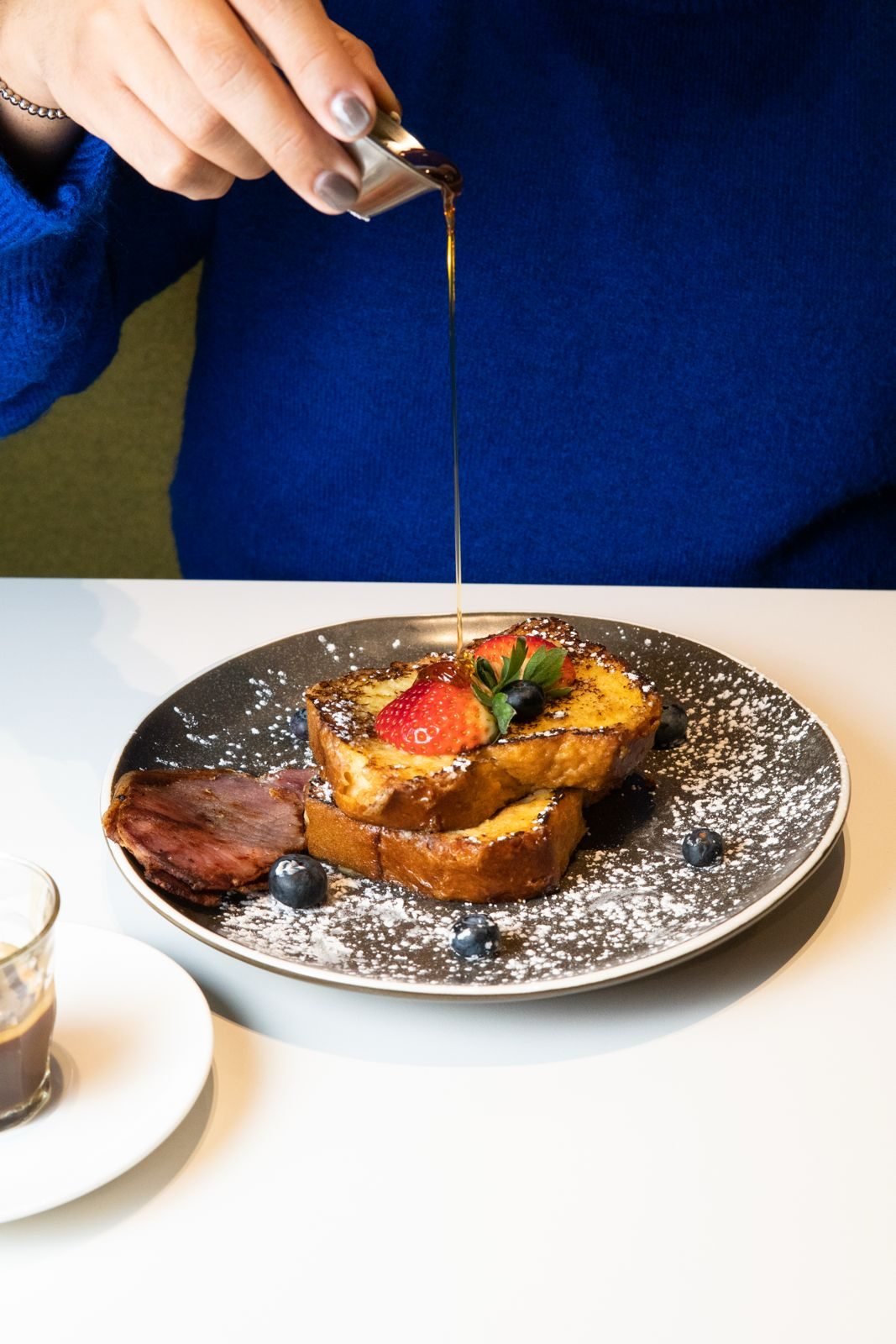 French toast with maple syrup, berries and bacon