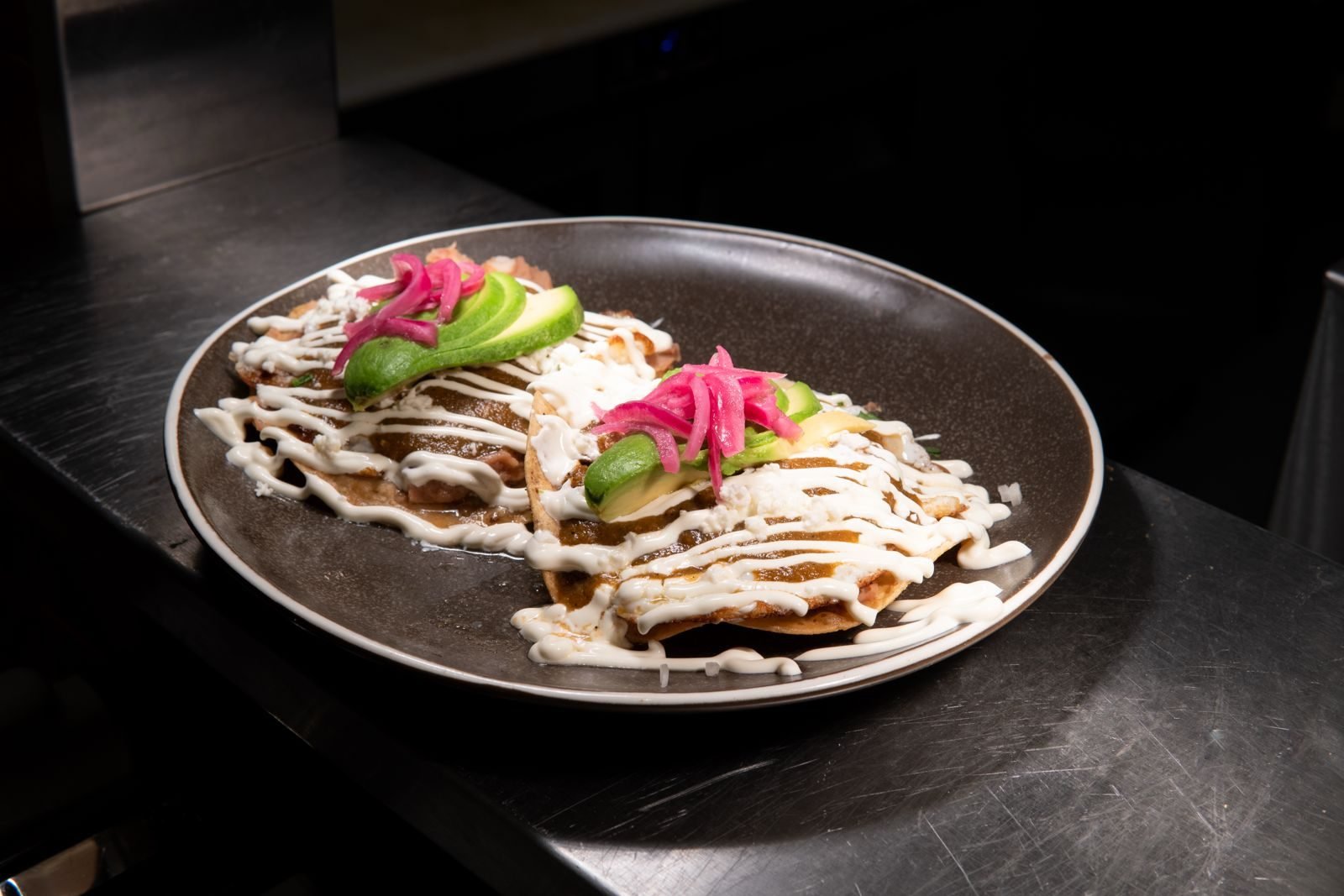 Tostadas with salsa verde, avocado and pickled onion